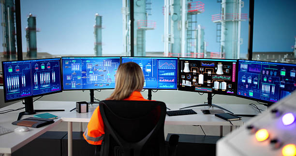 young female engineer monitoring oil and gas production with scada. young female engineer monitoring oil and gas production with scada.